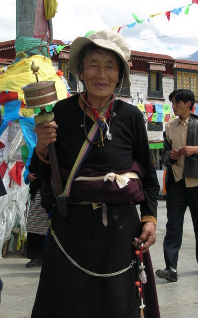 Tibetan woman with prayer wheel